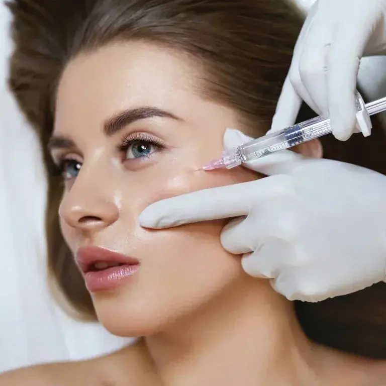 women undergoes her cheek filler injection treatment
