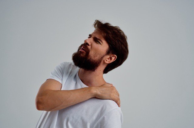 bearded man pain in the neck health problems massage therapy studio treatment. High quality photo