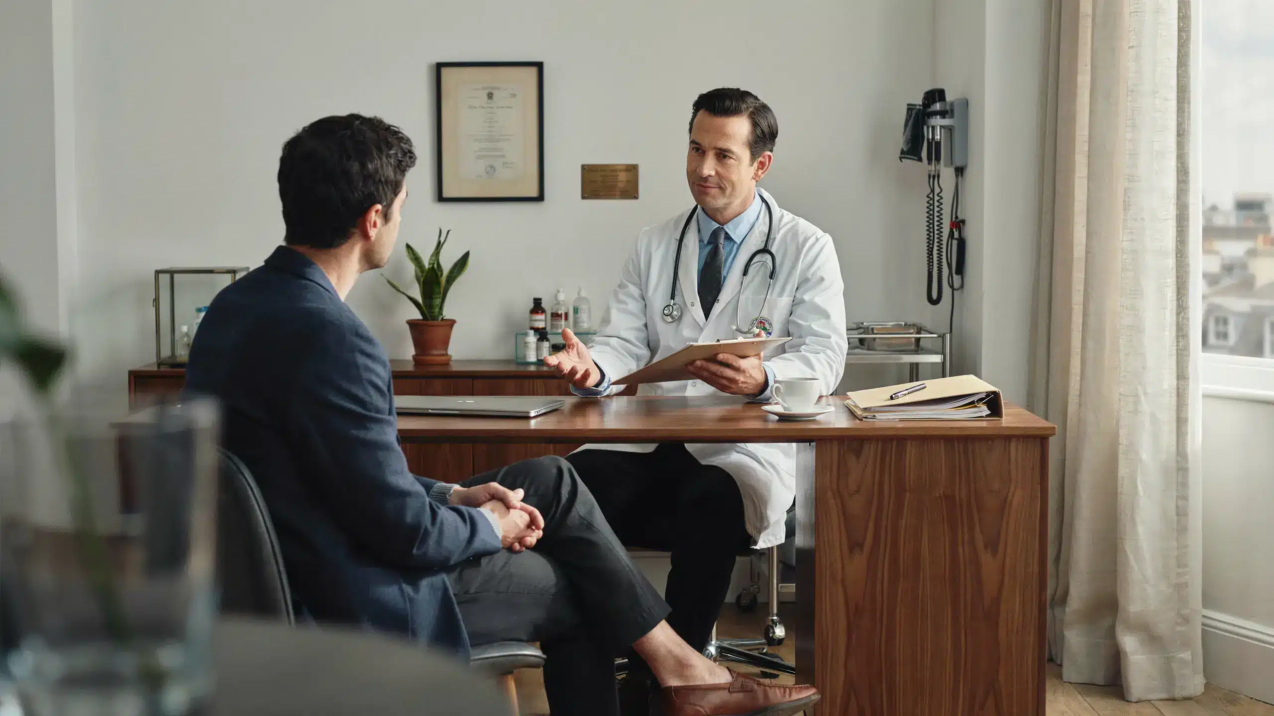 Male doctor discussing P-Shot cost and treatment options with a patient during a private consultation at a London clinic specialising in PRP therapy