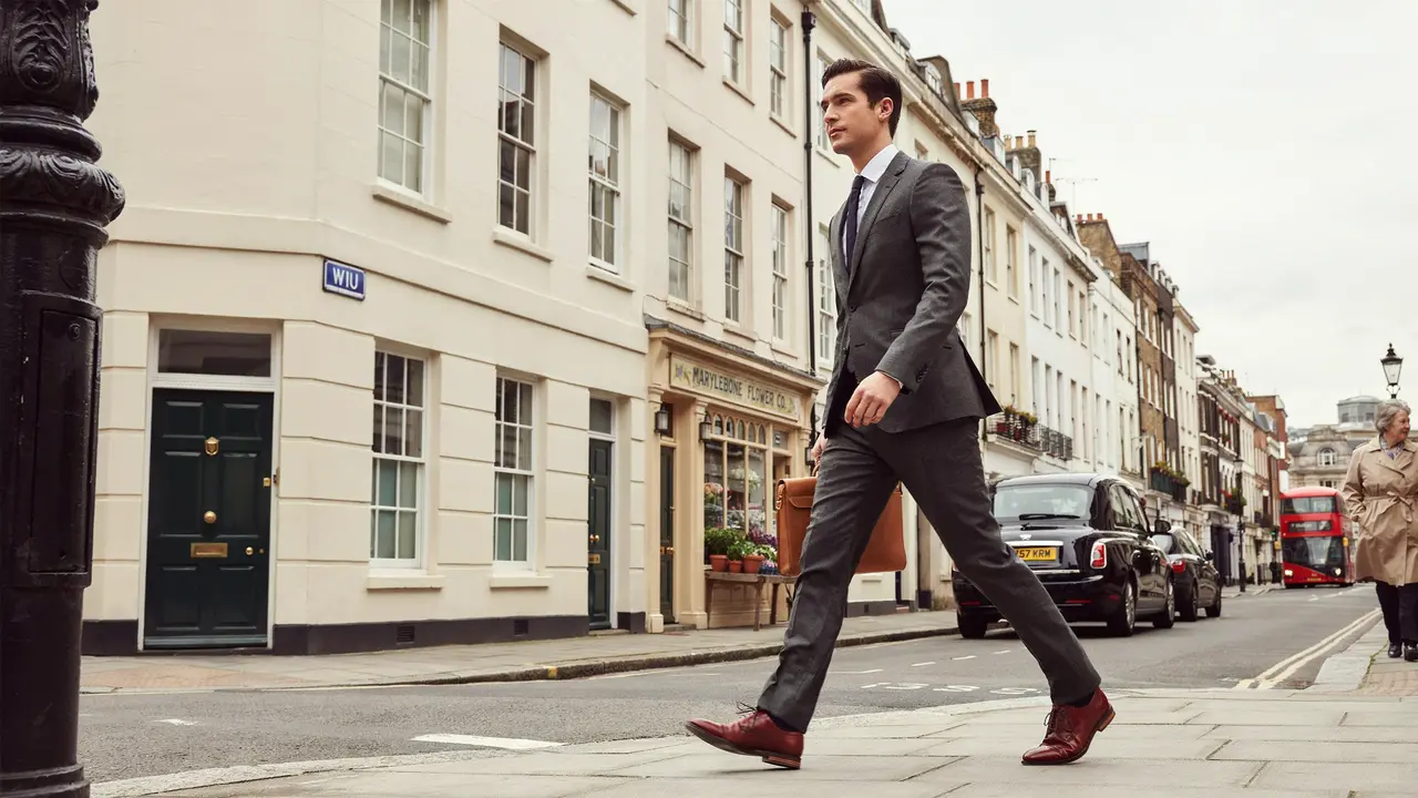 Well dressed man walking confidently through London street after P Shot treatment recovery at Dr SNA Clinic Wimpole Street Marylebone